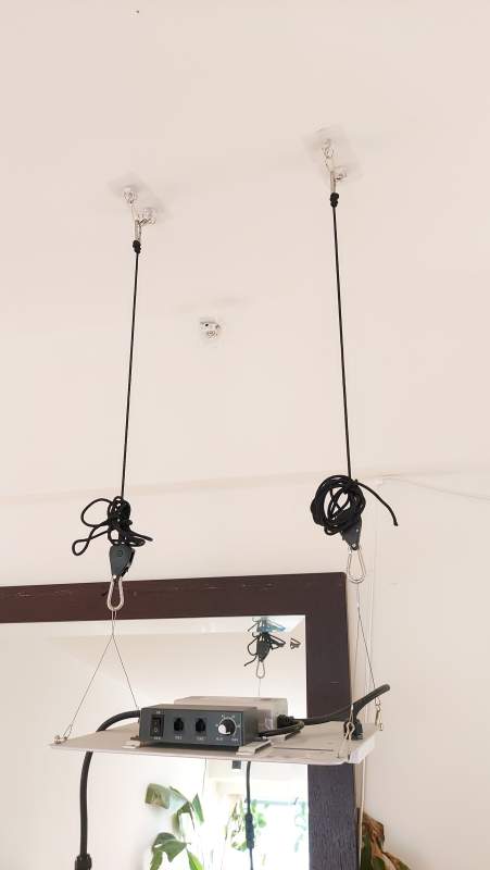 Spider Farmer SF1000 hanging from the ceiling with sticky ceiling hooks